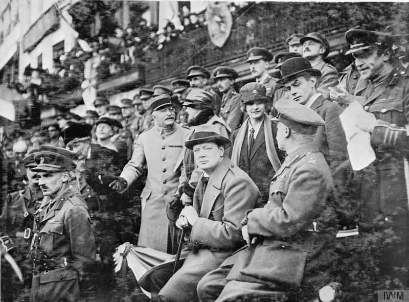 Winston Churchill, the Minister of Munitions, observed the parade of the 47th Division on the Grande Place of Lille. Lieutenant-Colonel Bernard Montgomery, the Chief of Staff of the 47th Division, stands before him.