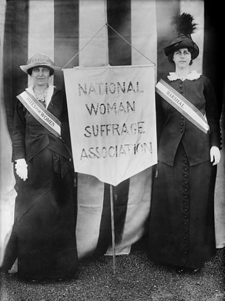 Suffragists holding a banner saying National Woman Suffrage Association